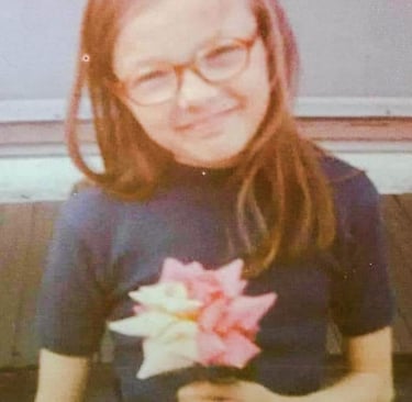 Mary Bielecki with glasses and a flower in her hand