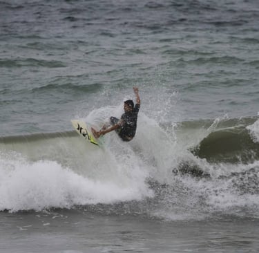 A surfer riding a crappy wave in windy day