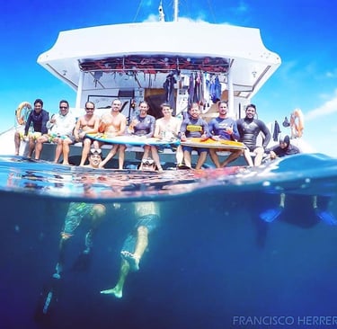 Group of surfers on a boat at the ocean