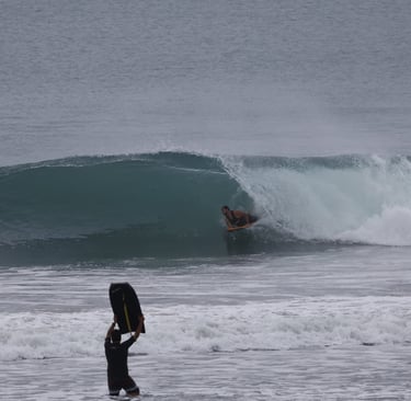 Bodyboarder riding a perfect right at a Ecuadorian Beach break