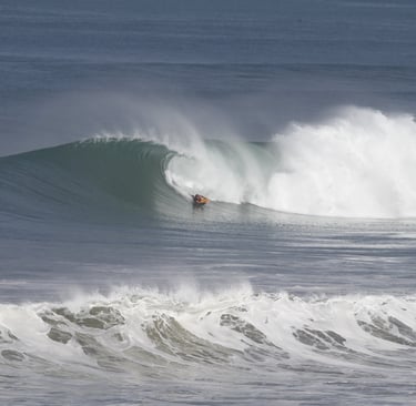 Surfer guide riding a perfect wave at an ecuadorian beach break