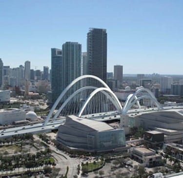 a city skyline view of a bridge spanning the city of downtown miami