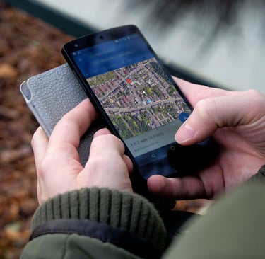 a person holding a cell phone in their hand