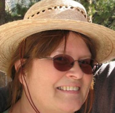 smiling woman in sunglasses and straw hat