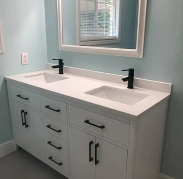 Renovated bathroom with double vanity and modern fixtures at Malad House. Premium Boise State student housing in Boise.