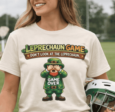 Woman wearing a St. Patrick's Day Leprechaun Game t-shirt while holding a green lacrosse helmet.
