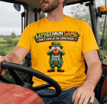 A man in a yellow Leprechaun Game t-shirt drives a tractor, featuring a funny St. Patrick's Day design.