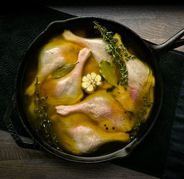 a pan of chicken with broth and vegetables in a skillet