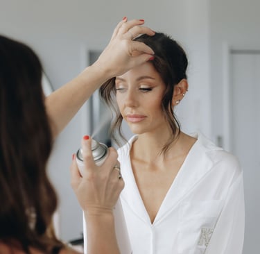 a woman is getting her hair styled by a professional hairdressucker