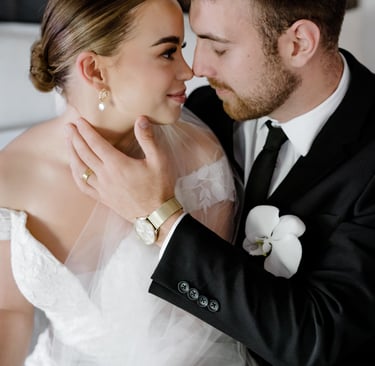a bride and groom kissing in a hotel room