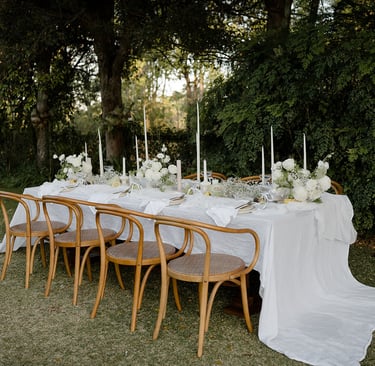 a table with a long table cloth and candles
