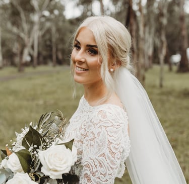a bride in a white wedding dress with a veil