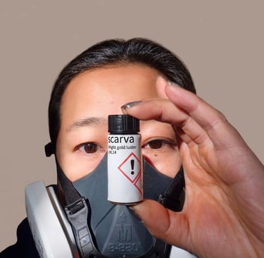 Studio safety: Wearing a respirator mask while holding Scarva gold luster.