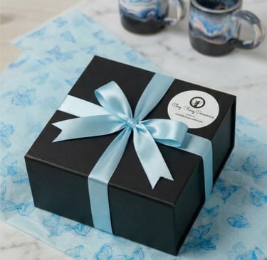 Gift-wrapped Irish pottery in a luxury black box with blue ribbon for international tracked shipping