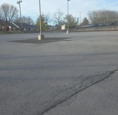 a parking lot needs sealcoaitn and striping