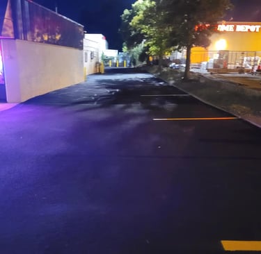 Sealcoated parking lot showing improved durability, restored color, and well-protected asphalt 