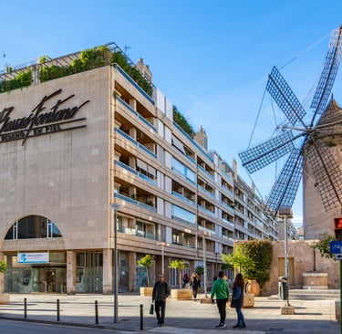 a windmill in front of a building in Mallorca