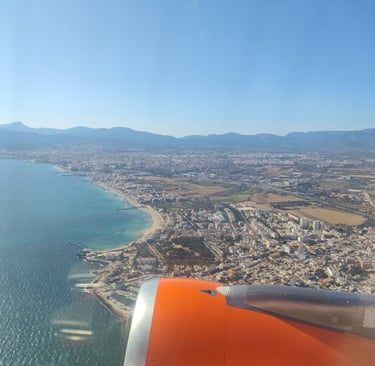 a view of a plane flying over a Mallorca
