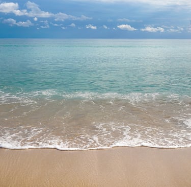 beach with crystal clear water washing on the sand in Playa de Muro Mallorca