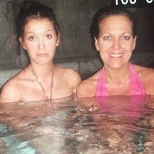two women in bikinis are sitting in a hot tub Dakota and Erin