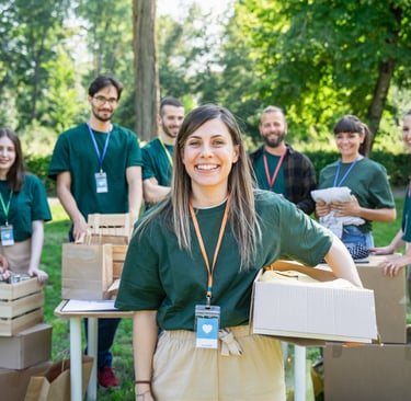 Group of volunteers outdoors organizing and packing donation boxes