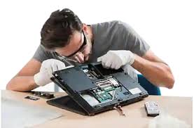 a man is repairing a laptop computer