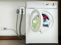 a washing machine with a washing machine in the background