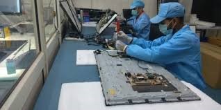 a group of people in blue coats and blue jackets working on a laptop