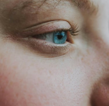 a close up of a woman's eye with a blue eye