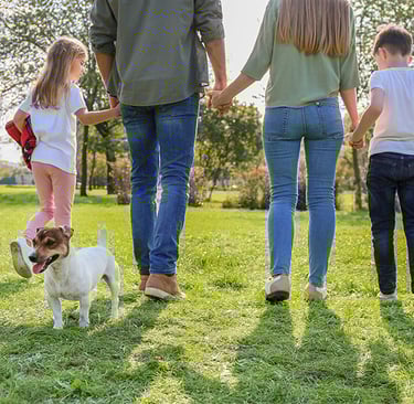 a family of three children playing soccer in a field