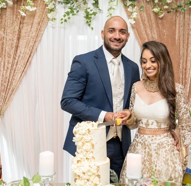 candid photo asian bride and groom cutting cake both happy and smiling 