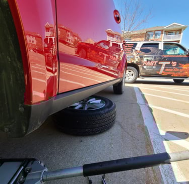 Car lifted on Jack being fixed by Fast T's Auto Repairing Services
