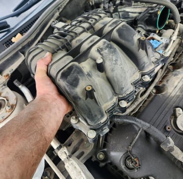 Fast T's Master Tech removing an intake manifold from a Honda accord to replace the intake gasket and spark plugs