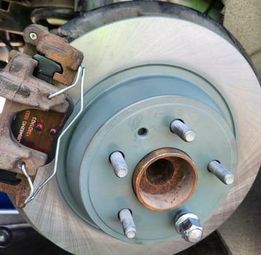 New brake pads and brake rotors installed on a vehicle near Waukee, Iowa by Fast T's Mobile Master Brake Technician