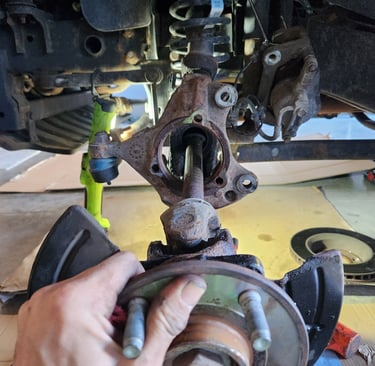 Fast T's Axle Technician removing an axle from the front differential in a customers garage