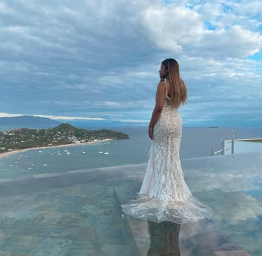 a woman in a white dress standing on a glass table