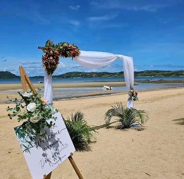 a wedding ceremony with a sign board with a picture of a man and woman