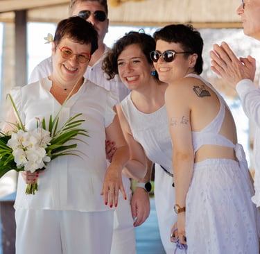 a group of people standing around a woman in a white dress