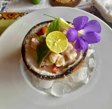 a coconut shellfish dish with flowers on ice