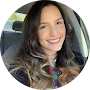 a woman in a car with a cell phone in her hand