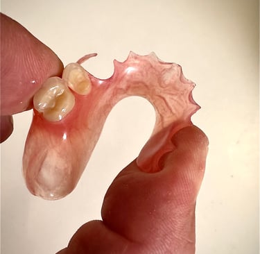 a person holding a toothbrush and a toothbrush