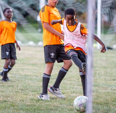 MVB F.C. Soccer player kicks a soccer ball during soccer practice outdoors Mississauga