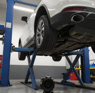 Close-up of a high-performance perforated brake disc and red caliper on a vehicle in a repair shop.