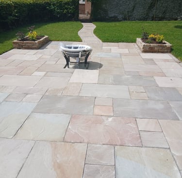a patio with a table and chairs in the yard