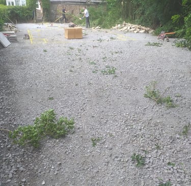 a man standing in a gravel road with a box of boxes
