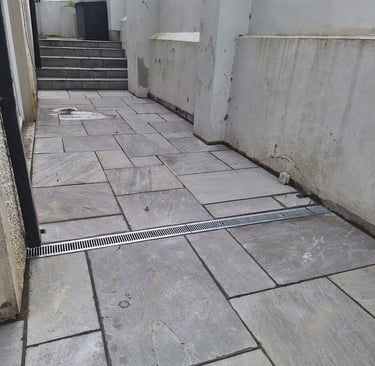 a tiled floor with a drain in the middle of the floor