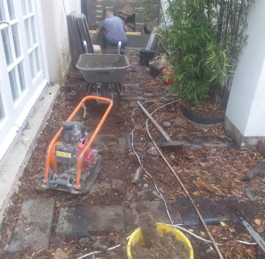 a man is working on a garden with a wheelbar