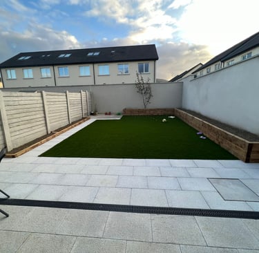 a backyard patio with a lawn and a lawn chair
