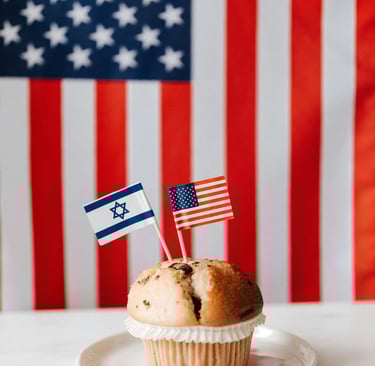 Photo of a muffin with tiny US and Israel flag on toothpicks