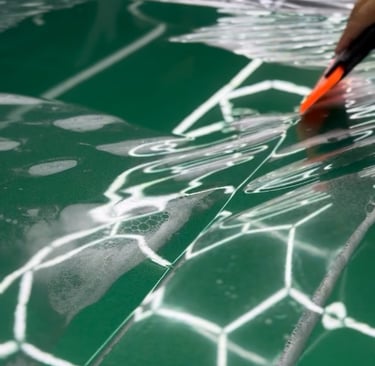 Clear PPF film protecting car paint from rock chips.